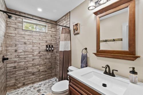 a bathroom with a sink and a shower and a mirror at Hot Tub and Community Beach Albrightsville Home! in Albrightsville