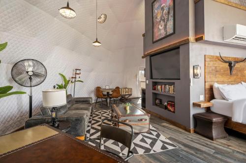 a living room with a couch and a tv at Luxury Glamping Dome on Texas Farm in San Marcos