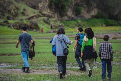a group of people walking down a dirt road at Wenchi Eco-lodge in Dirē Kʼalu