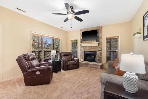 a living room with a couch and chairs and a fireplace at Stonebridge Hideaway - For 6 in Branson West