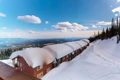 a train covered in snow on top of a mountain at Aspens 4607 in Big White