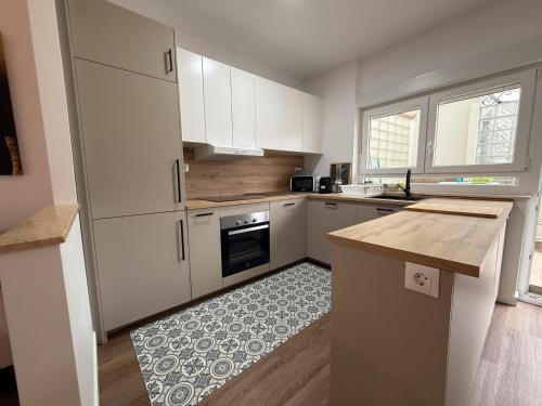 a kitchen with white cabinets and a counter top at Abastos in Santoña
