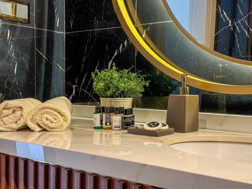a bathroom counter with a sink and a mirror at Qoople Legend B - premium apartments steps from the sea in Alanya