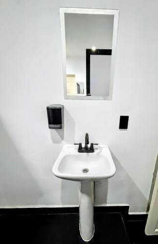 a white sink in a bathroom with a mirror at Casa Amelio Roma Norte in Mexico City