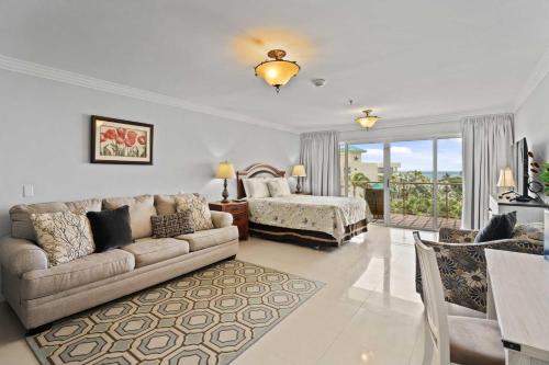 a living room with a couch and a bed at Beachfront - Best Beach View Studio - E422-1 in Palm-Eagle Beach