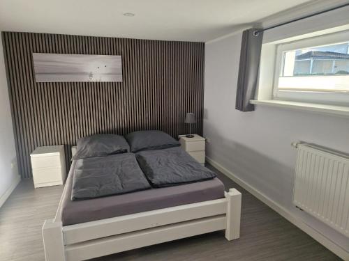 a bedroom with a bed in a room with a window at Leuchters Unterkunft in Bad Doberan
