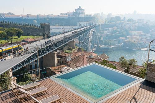 a bridge over a river with a swimming pool at GuestReady - D. Hugo Boutique Hotel B&B in Porto