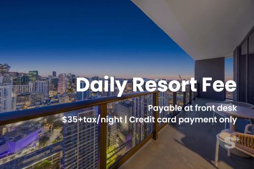 a view of a city from a balcony with the words daily resort fee payable at at Stylish City Condo in the Heart of Downtown Miami in Miami
