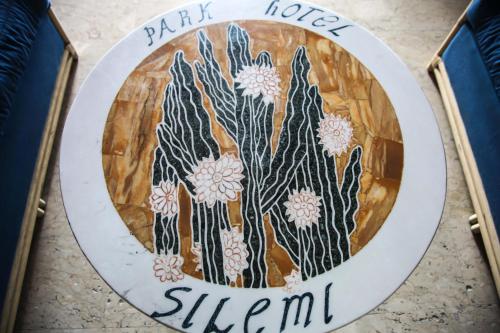 a sign that says park house stevian at Park Hotel Silemi in Letojanni