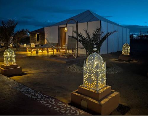 a building with lights in front of a building at Unique Luxury Camp in Merzouga