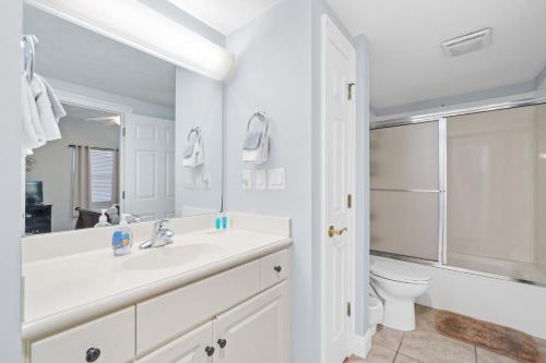 a white bathroom with a sink and a toilet at Treasure Island 707 in Panama City Beach