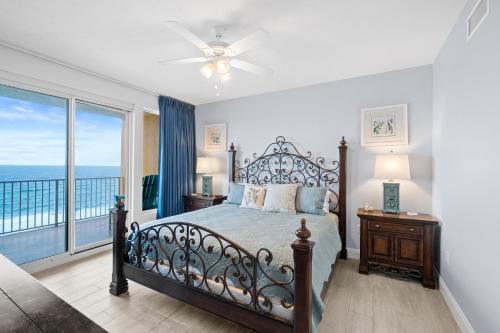 a bedroom with a bed with a view of the ocean at Treasure Island 707 in Panama City Beach