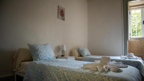 a bedroom with two beds with stuffed animals on it at Casa de Santa Luzia in Mirandela