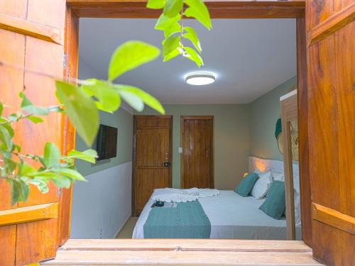 a bedroom with a bed with blue pillows at Pousada Céu da Chapadha in Mucugê