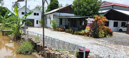 a flooded street in front of a house at Homestay A&R Home in Yan