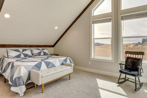 a bedroom with a bed and a chair and windows at Mtn and Lake Views Family Retreat in Garden City! in Garden City