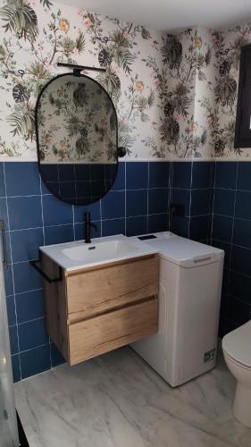 a bathroom with a sink and a mirror and a toilet at Urban relax in Dos Hermanas