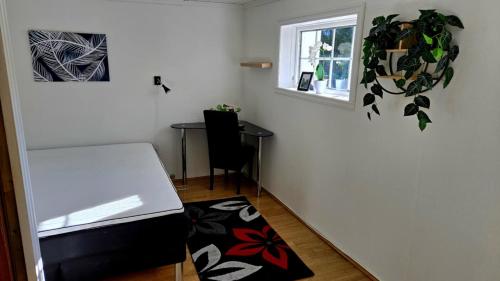a small room with a table and a window at Lovely Home In Sauda With Wifi in Sauda