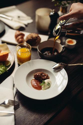Una mesa de madera con un plato de comida encima. en Varbergs Kusthotell, en Varberg