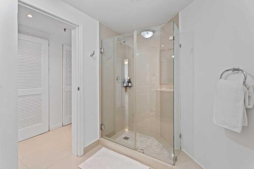 a shower in a bathroom with a glass shower stall at Beachfront - Best View 2BR condo - E422-2 in Palm-Eagle Beach