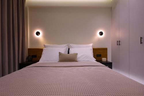 a bedroom with a large bed with white pillows at Aristotelous rooms Nikol in Thessaloniki