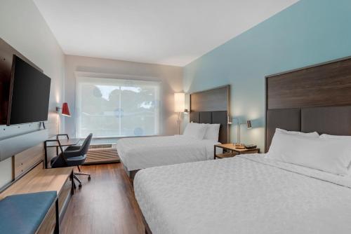 a hotel room with two beds and a flat screen tv at Tru By Hilton Gastonia in Gastonia