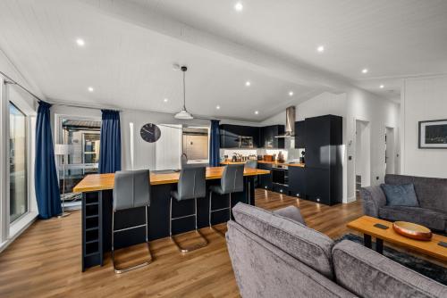 a kitchen and living room with a couch and a table at Silverwood Luxury Lodge Resort, 37 individual stunning properties in Perth