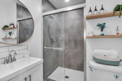 a shower with a glass door in a bathroom at Galleria Apartments By Lowkl in Fort Lauderdale