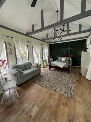 a living room with a couch and a bed at Courtyard by Ravens Keep in Jackson