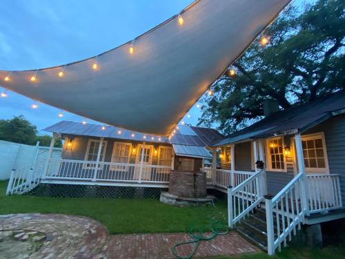 a house with a porch with lights on it at Courtyard by Ravens Keep in Jackson
