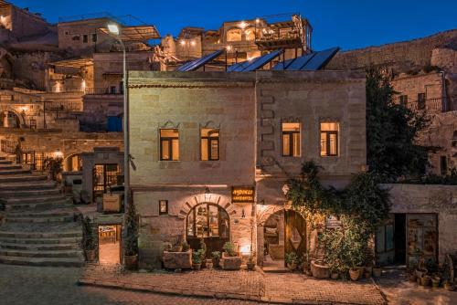 a building with lights on top of a mountain at Aydinli Cave Hotel in Göreme