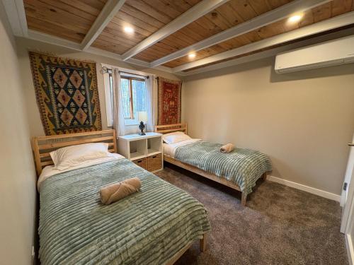 a bedroom with two beds and a window at Walking Distance to the Beach Cabin with AC in Arrowhead Lake