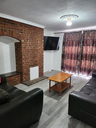 a living room with a couch and a table at 5 minutes from station and 1 minute to A13 in Dagenham Dock