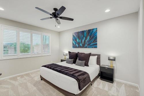 a bedroom with a bed and a ceiling fan at Blue Agave Dreams in Marana