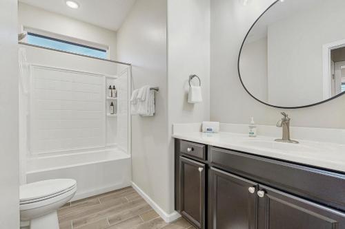 a bathroom with a sink and a toilet and a mirror at Blue Agave Dreams in Marana