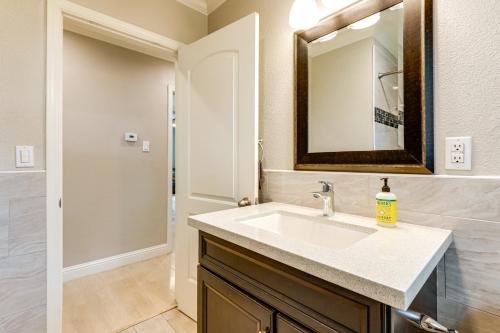 een badkamer met een wastafel en een spiegel bij Charming Retreat 1 Mi to UC Davis Medical Center in Oak Park