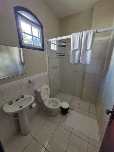 a bathroom with a shower and a toilet and a sink at 4 Ventos Pousada in Paraty