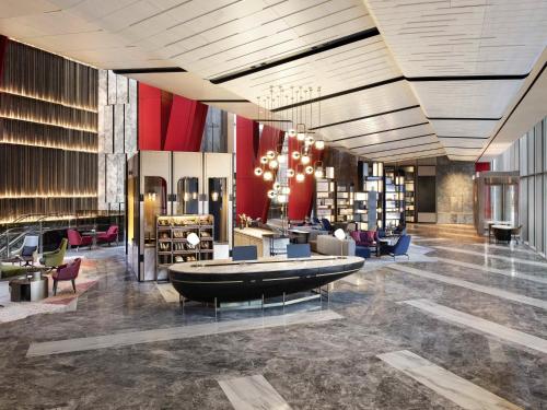 a lobby with a library with a large couch in the middle at Fairmont Ambassador Seoul in Seoul