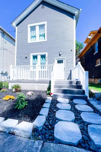 a house with a stone path in front of it at Perfect 6BR Stay Near Niagara Falls & Attractions in Niagara Falls