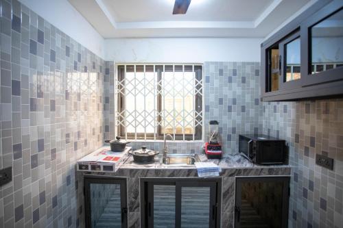 a kitchen with a sink and a window at My Little Home - Miz Platzli in Ashalebotwe