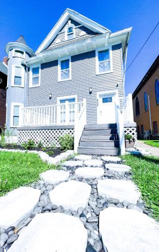 a house with a stone walkway in front of it at Group Friendly 6BR Near Aquarium & Niagara Falls in Niagara Falls