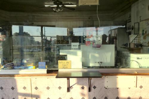 a window of a kitchen with a bench in it at Cole Manor Motel By OYO Love Field Market Center in Dallas