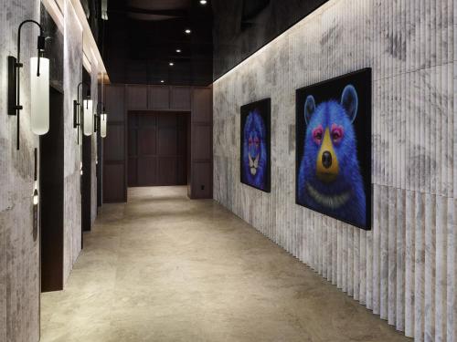 a hallway with two paintings of a bear on the wall at Mondrian Seoul Itaewon in Seoul