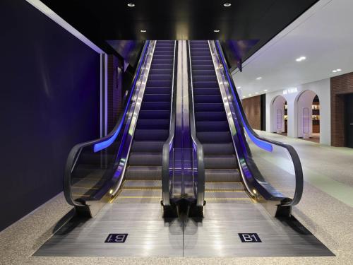 an empty escalator in a building with at Mondrian Seoul Itaewon in Seoul