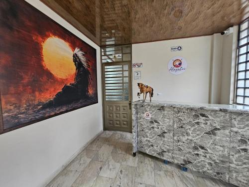 a dog standing on a counter in a room with a painting at Arapahoe Resorts in Villavicencio