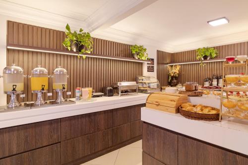 a buffet line in a restaurant with food on display at Havana Palace Hotel in Uberaba