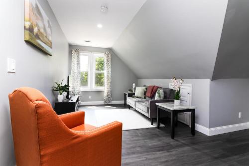 a living room with a couch and a table at Cozy Micro apartment, Minutes from Falls in Niagara Falls