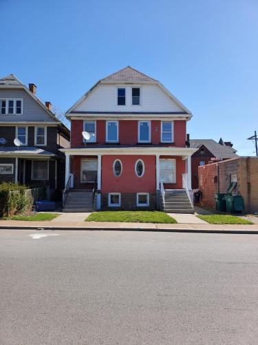 a red house on the side of a street at 5BR Niagara Getaway Prime Location-Sleeps 10 in Niagara Falls