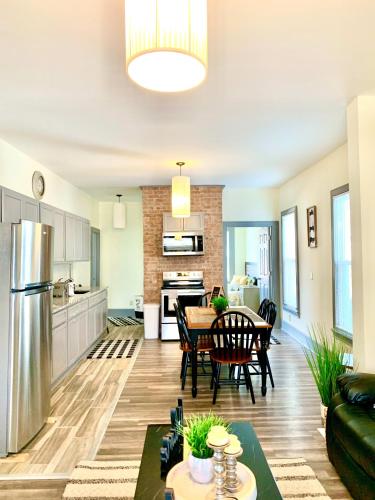 a kitchen and living room with a table and chairs at Perfect 6BR Stay Near Falls & Attractions in Niagara Falls