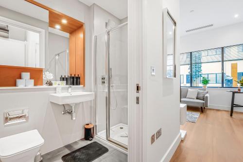 a bathroom with a shower and a sink at The Cosy Luxe in Slough